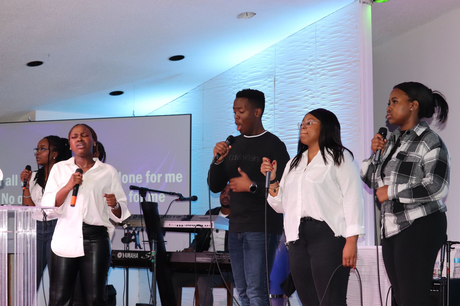 Congregation worshipping with hands raised during a church service