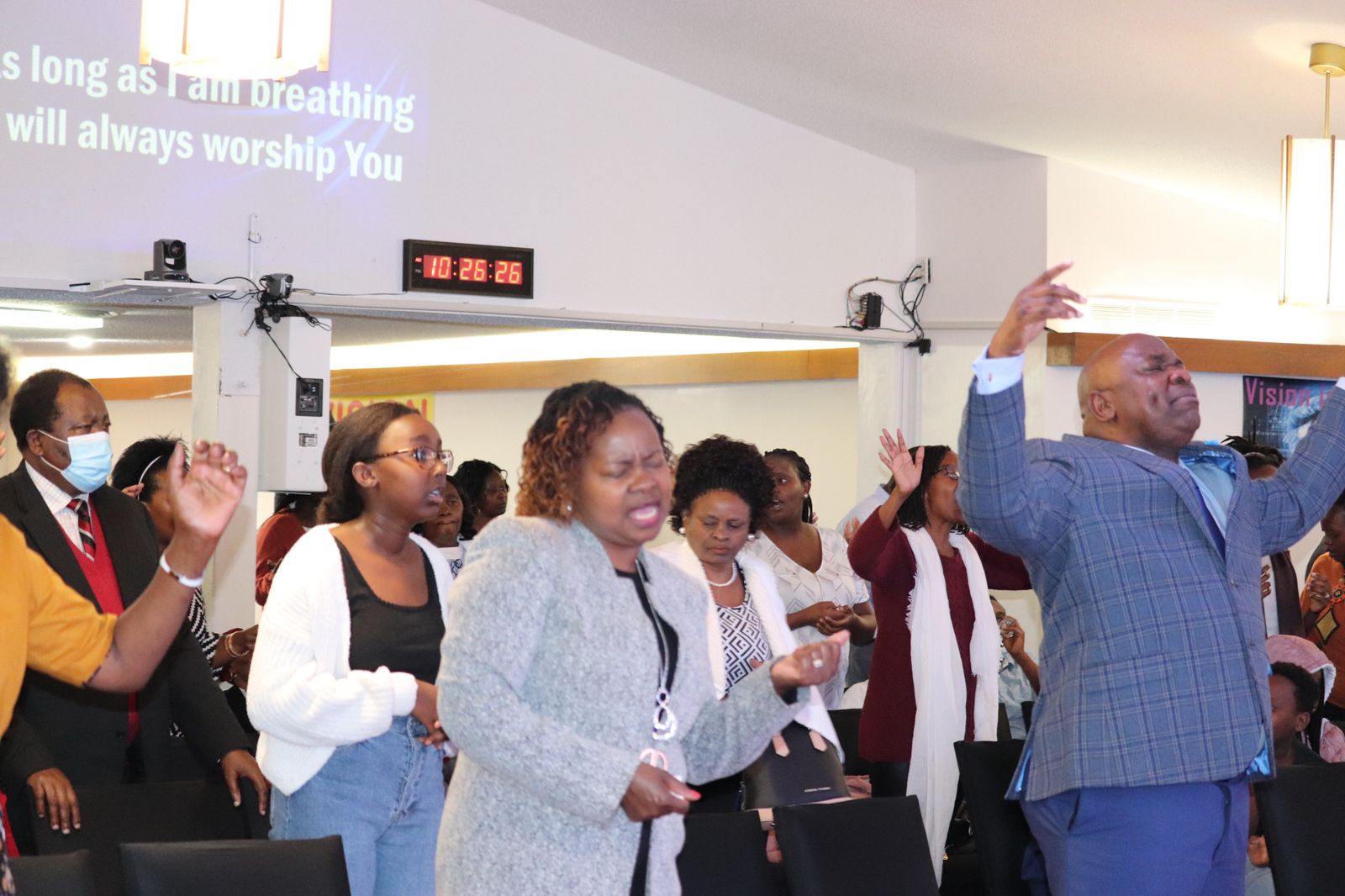 Hands clasped in prayer over an open Bible