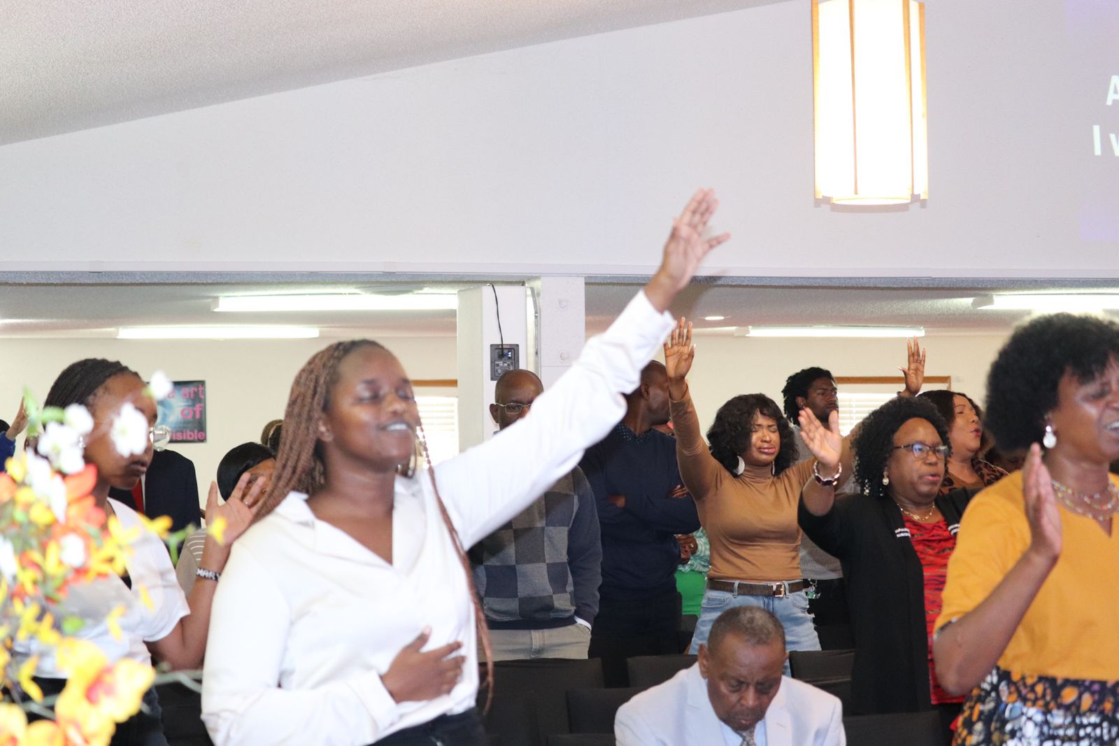 A group joining hands together in prayer