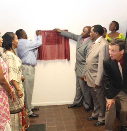 Image of church members opening the curtain for launching the church